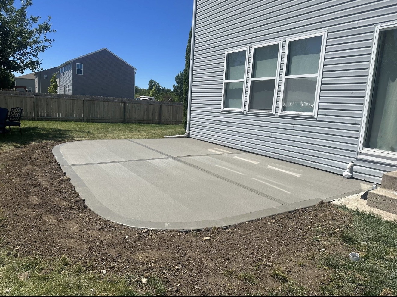 Freshly poured concrete patio with rounded edge