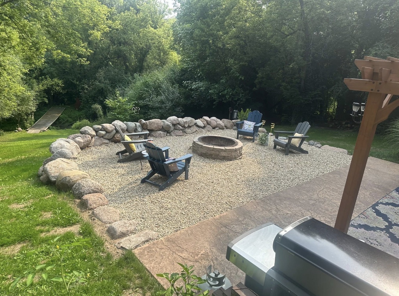 Gravel lounge area with boulder border and fire pit