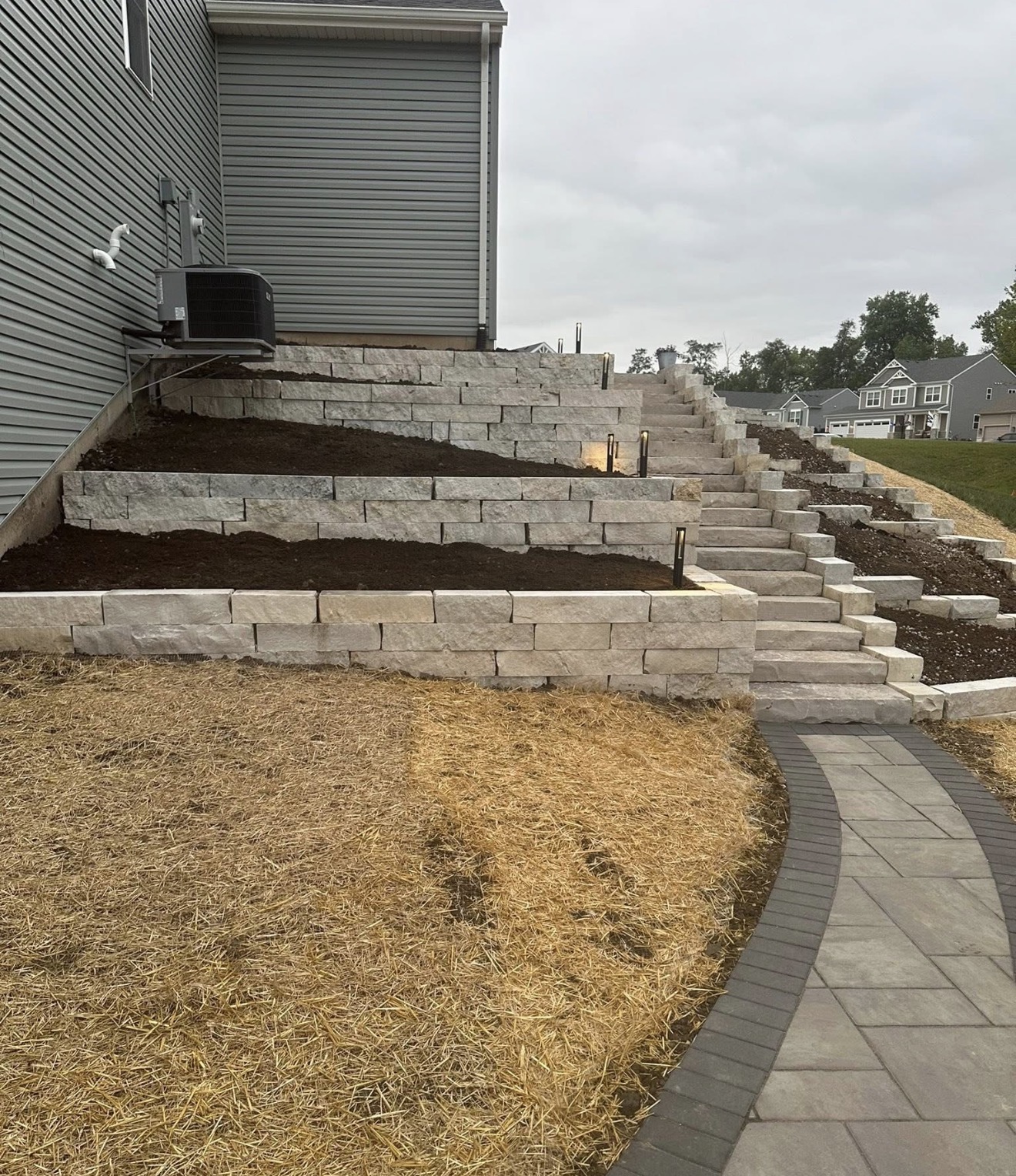 Multi-level natural stone retaining wall with staircase