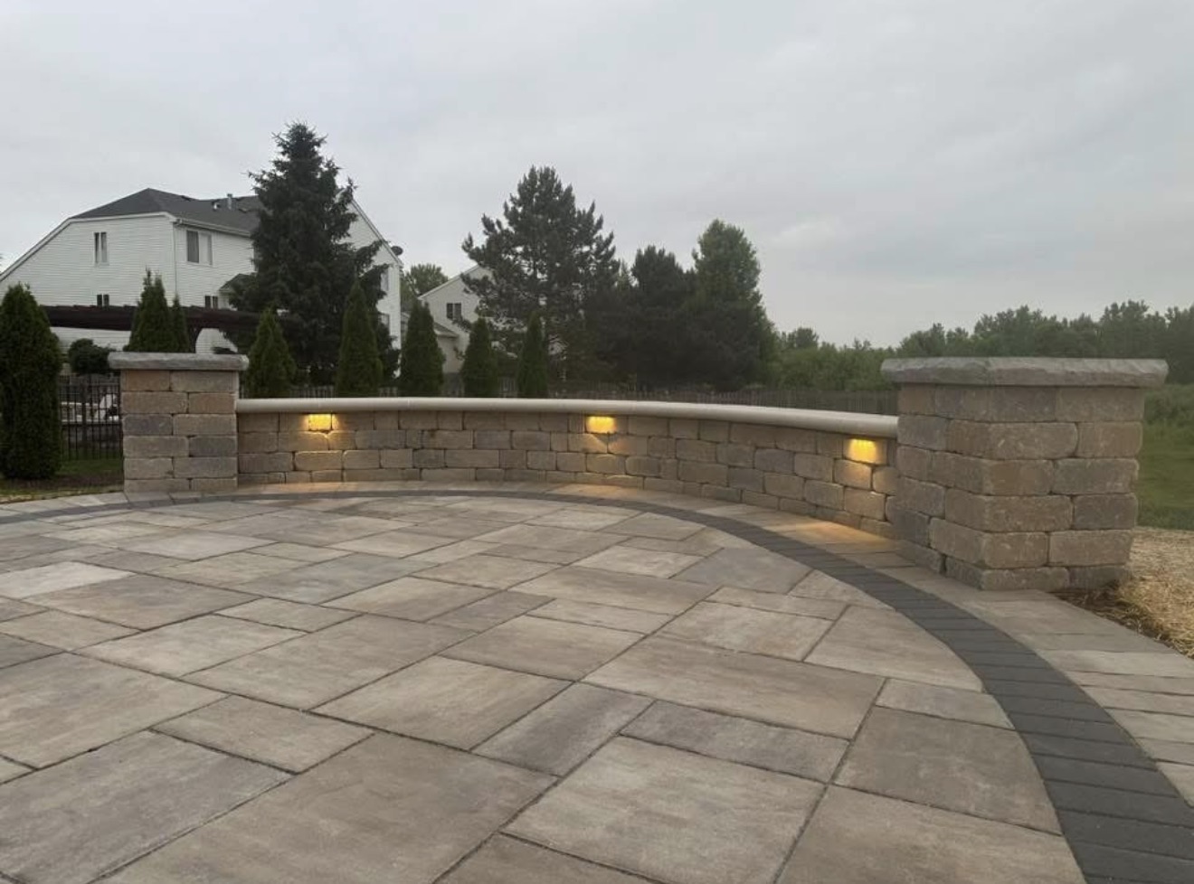 Curved seat wall with column caps and integrated lighting